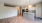 spacious living area with wooden flooring next to kitchen